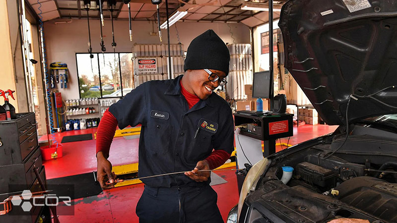 worker changing oil